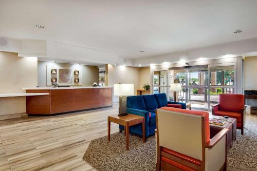 a living room with a couch and chairs and a table at Comfort Inn Airport in Roanoke