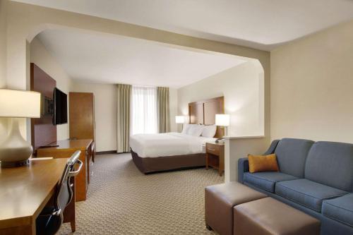a hotel room with a bed and a couch at Comfort Inn Airport in Roanoke