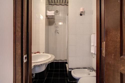 a bathroom with a sink and a toilet at Hotel Castel Vecchio in Castel Gandolfo