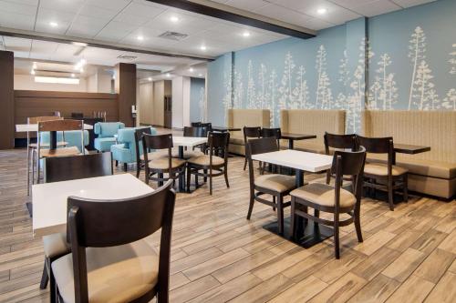 a waiting room with tables and chairs in a dental office at Sleep Inn Dallas Northwest - Irving in Dallas