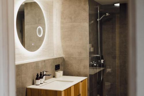 a bathroom with a sink and a shower at DER*ADLER Apartments in Schoppernau