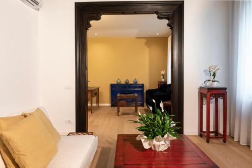 a living room with a couch and a mirror at Villa Gallo 1915, luxurious villa with garden and SPA in Venice-Lido