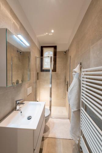 a bathroom with a sink and a toilet and a shower at Villa Gallo 1915, luxurious villa with garden and SPA in Venice-Lido