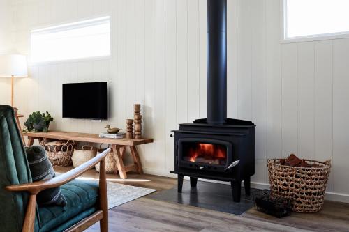 a living room with a stove in a room at Crittenden Lakeside Villas in Dromana