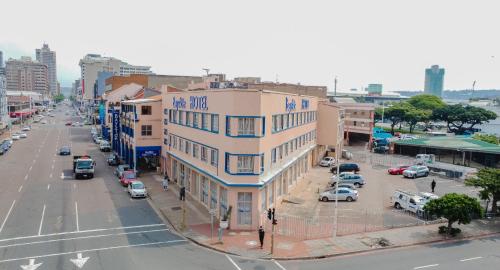 a building on a city street with cars parked at Bayside Hotel 116 West Street in Durban