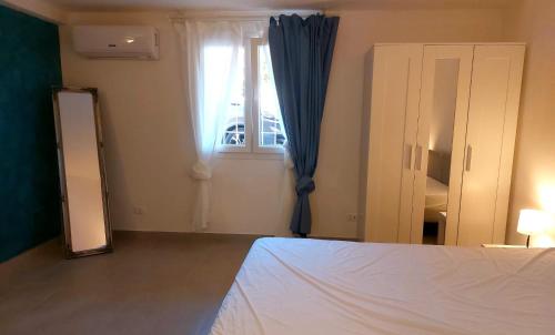 a bedroom with a bed and a mirror and a window at JAZZ STYLE - On The Beach - Anzio in Anzio