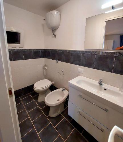 a bathroom with a toilet and a sink at JAZZ STYLE - On The Beach - Anzio in Anzio