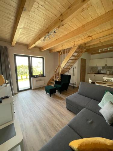 a living room with a couch and a table at Domki Błażejewo in Łukęcin