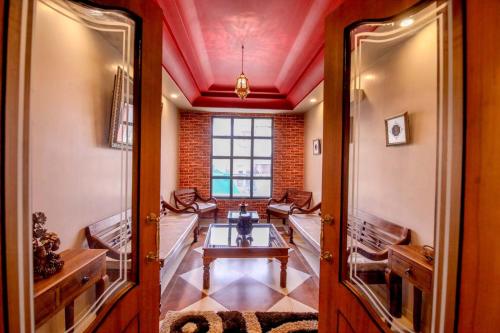 a room with a table and chairs and a window at Gems Suites-A Boutique Stay in Jaipur