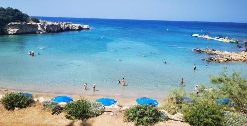 a group of people in the water at a beach at GREAT VILLA MARIA in Paralimni