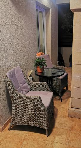 a living room with two chairs and a table at GREAT VILLA MARIA in Paralimni
