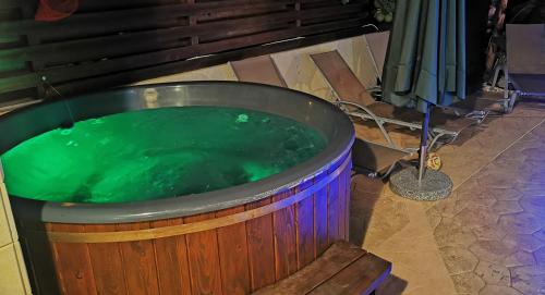 a large wooden tub filled with green water at GREAT VILLA MARIA in Paralimni