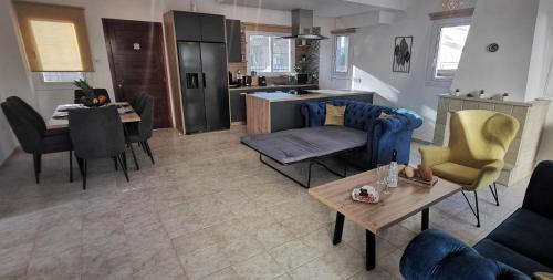 a living room with a couch and a table at GREAT VILLA MARIA in Paralimni