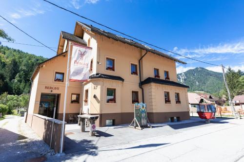 a building with a sign on the side of it at Berghi Hotel and Apartments in Kranjska Gora