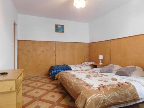 a bedroom with a large bed and a desk at Pokoje gościnne Edan in Łeba