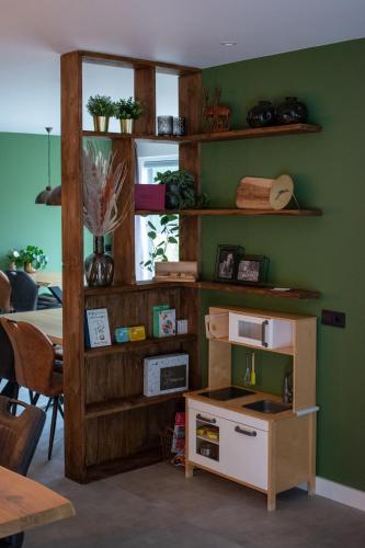 a kitchen with a table and a microwave on a shelf at Hotel B&B Buiten Loon in Loon op Zand