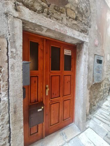 a wooden door on the side of a stone building at Seabed Apartma 1 in Piran