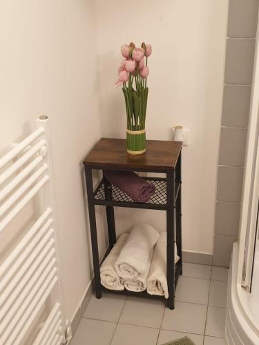 a small table with a vase of flowers on it at Apartmány Prášily in Prášily
