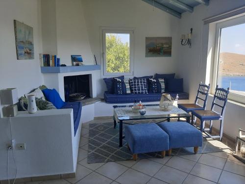 a living room with a couch and a table and chairs at Vourkari BayHouse in Vourkarion