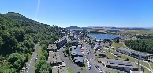 an aerial view of a street with cars parked on the road at STUDIO DE LA BICHETTE in Besse-et-Saint-Anastaise