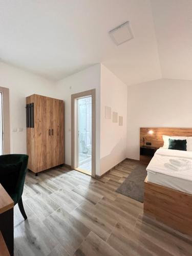 a bedroom with a bed and a wooden floor at Prenociste kod Brana in Čačak