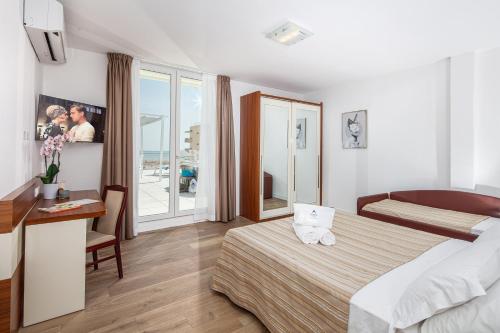 Un ou plusieurs lits dans un hébergement de l'établissement Hotel Danieli