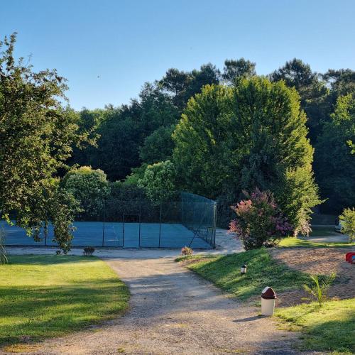 a park with a volleyball court and a net at La Forêt Enchantée in Cornille