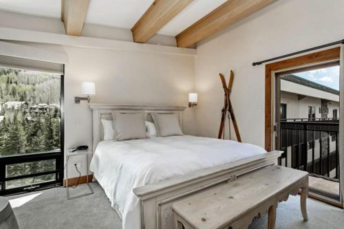 a bedroom with a bed and a large window at 3 Bedroom Antlers Vacation Rental With Incredible Slopeside Views And Just A Short Walk To Gondola And Lionshead Village in Vail