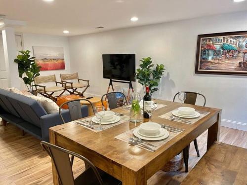 a living room with a wooden table and chairs at Upscale, Brand New, Full Kitchen, 2-Bedroom Apt in Falls Church