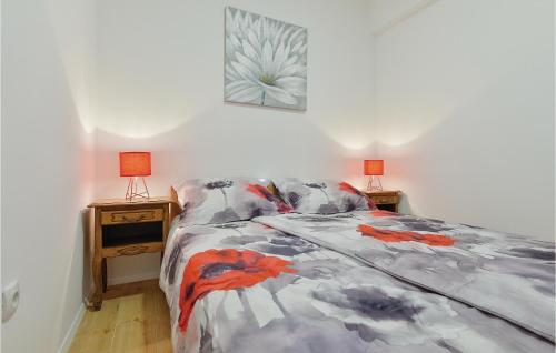 a bedroom with a bed and two lamps on a table at Lovely Home In Tuhelj With Sauna in Tuhelj