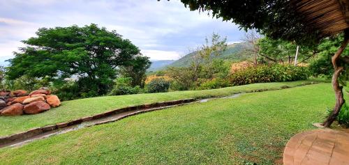 a pile of rocks sitting on top of a grass field at Wide Horizons Mountain Retreat in Malkerns