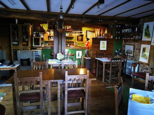 a restaurant with tables and chairs and a bar at Alcázar Milmanda in Milmanda