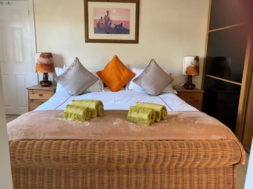 a bedroom with a bed with two pillows on it at Hygge Somerset in Street