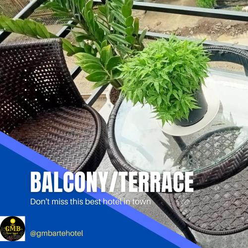a picture of a patio with a table and plants at Gmb-Arte' Hotel in Sogod