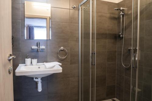 a bathroom with a sink and a shower at Ubytování Na Peci Lanžhot in Lanžhot
