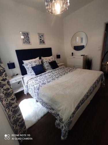 a bedroom with a large bed and a chandelier at L'EDEN DU LYS in Cauterets