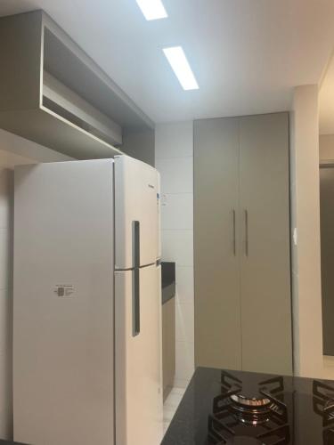 a kitchen with a refrigerator and a stove at Mardisa Design by Jess Hospedagens in João Pessoa