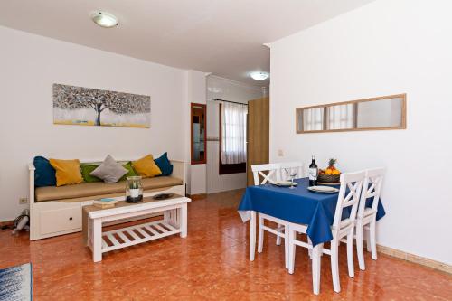 a living room with a table and a couch at Apartment Lima Prime Location Playa Blanca By PVL in Playa Blanca