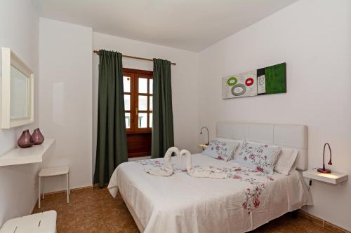 a bedroom with a white bed with green curtains at Apartment Lima Prime Location Playa Blanca By PVL in Playa Blanca