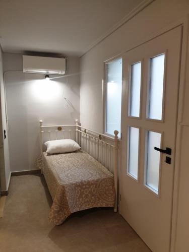 a small bedroom with a bed and a window at Lavender Green Villas in Agios Nikitas