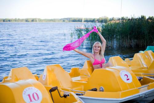 a girl in a pink dress sitting on a pedal boat at SELMENT RESORT Mazury in Ełk