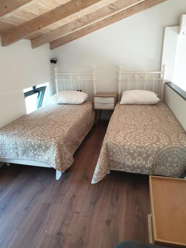 two beds sitting next to each other in a room at Lavender Green Villas in Agios Nikitas