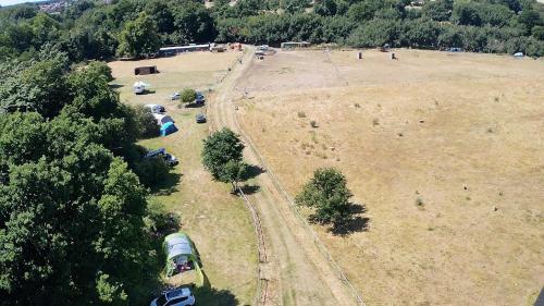 an aerial view of a field with a train on the tracks at Tent Pitch only no accommodation supplied in Elsenham