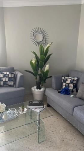a living room with a couch and a table at madrigal 1-3br with parking in Santiago de los Caballeros