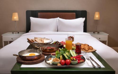 a tray of breakfast foods on a bed at Catch Sultanahmet-Special Class in Istanbul