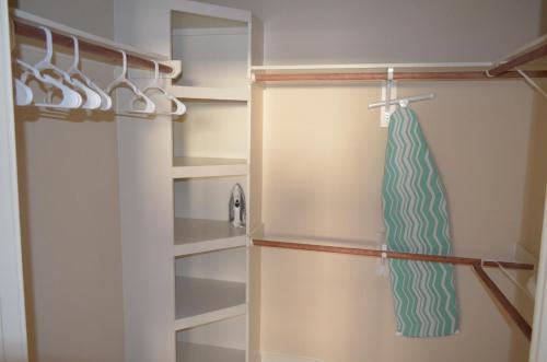 a closet with a towel hanging on a rack at Hanover Post Oak in Houston
