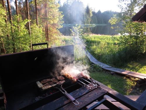 a grill with a bunch of food on it at Käbi Holiday Homes in Ainja