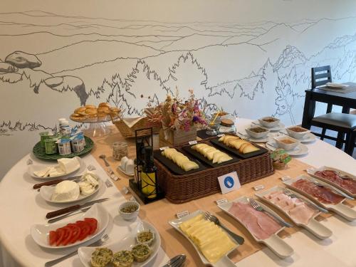 a table with a buffet of food on it at Hotel da Vila in Manteigas