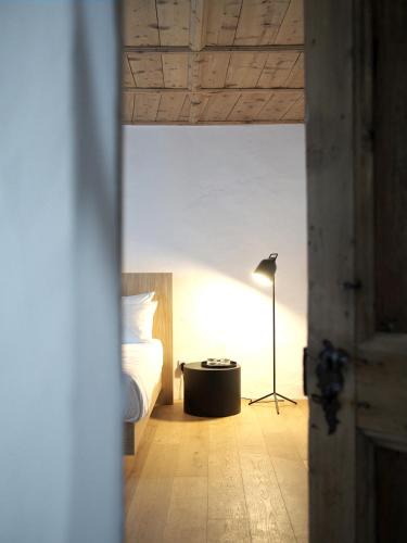 a bedroom with a bed and a floor lamp at Marktplatz 10 in Caldaro