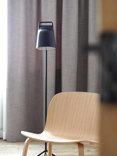a lamp sitting next to a chair next to a window at Marktplatz 10 in Caldaro